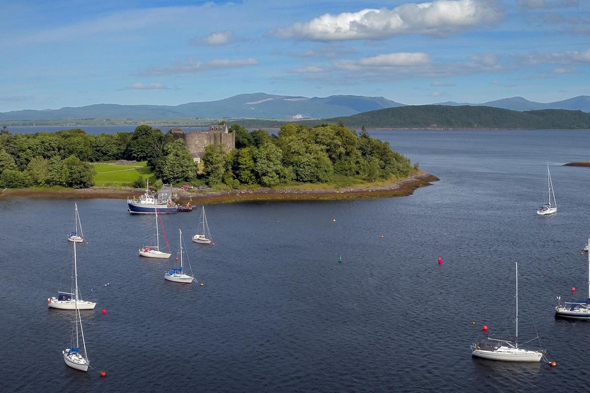 Yachts moored in the shadow of historic Dunstaffnage Castle, near Oban