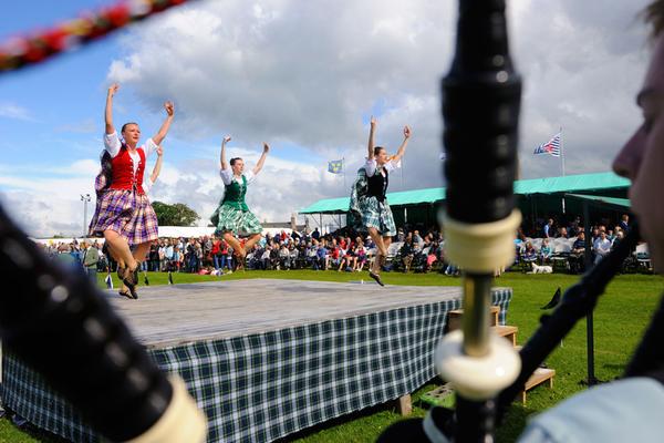 Dancers taking part in the Aboyne Highland Games to the sounds of bagpipes