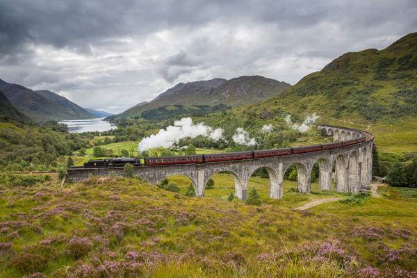 The Jacobite steam train passing over the Glenfinnan Viaduct at the head of Loch Shiel, Highlands